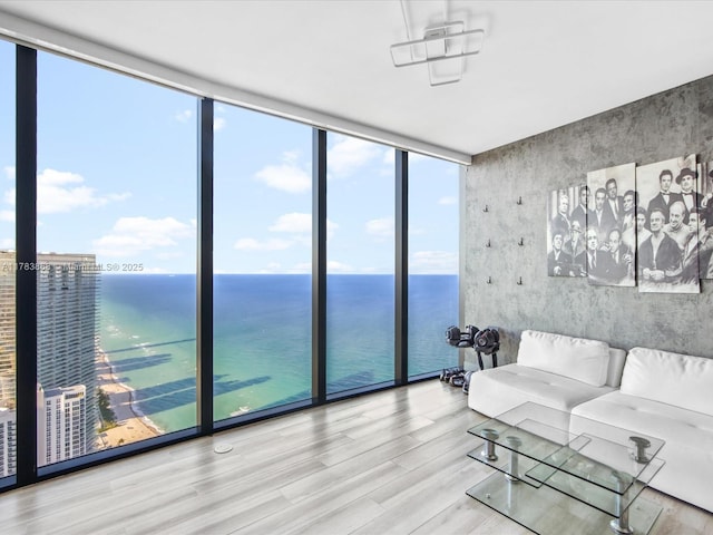 18555 Collins Ave Unit 5505, Sunny Isles Beach, FL 33160 - living room with expansive windows, wood finished floors, and a water view