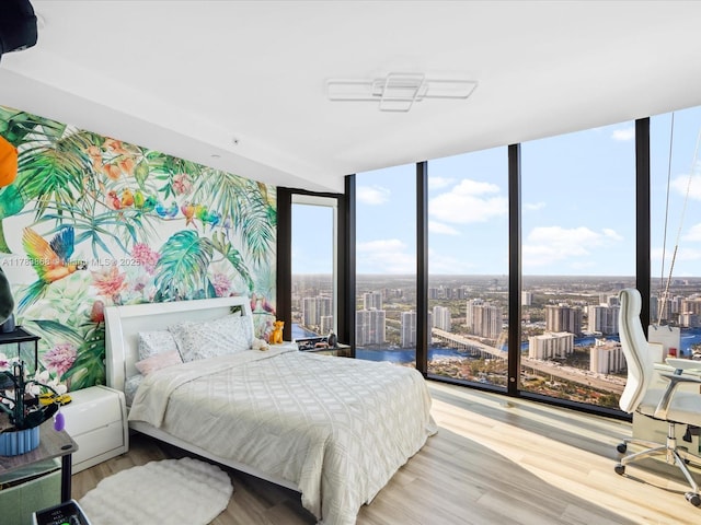 18555 Collins Ave Unit 5505, Sunny Isles Beach, FL 33160 - bedroom with a wall of windows, a view of city, and wood finished floors