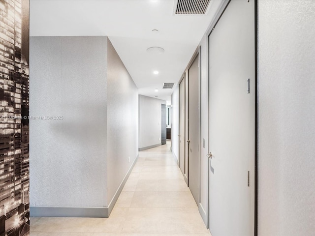18555 Collins Ave Unit 5505, Sunny Isles Beach, FL 33160 - hallway with baseboards, recessed lighting, and light tile patterned floors