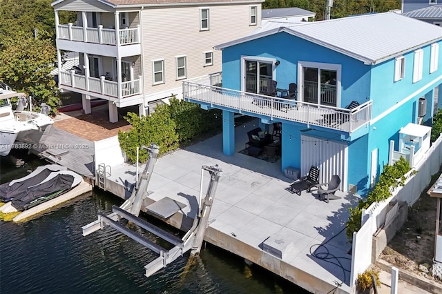234 Allen Ave, Key Largo, FL 33037 - rear view of house featuring boat lift, a patio area, a carport, and a water view