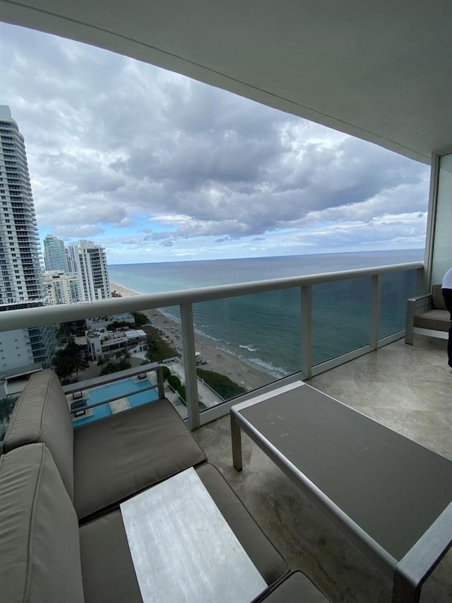 balcony featuring a city view and a water view