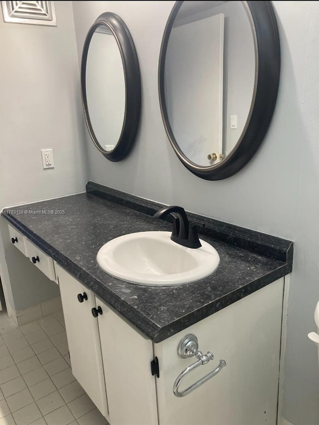bathroom featuring visible vents, tile patterned floors, and vanity