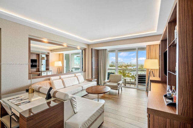 551 N Fort Lauderdale Beach Blvd Unit H1403, Fort Lauderdale, FL 33304 - living room featuring a tray ceiling and wood finished floors