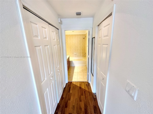 11202 NW 83rd St Unit 104, Doral, FL 33178 - hallway with dark wood-type flooring and visible vents