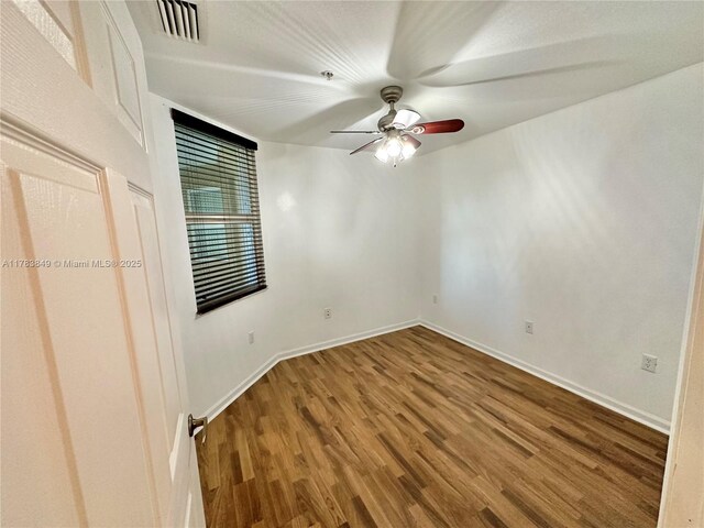 11202 NW 83rd St Unit 104, Doral, FL 33178 - spare room featuring wood finished floors, ceiling fan, baseboards, and visible vents