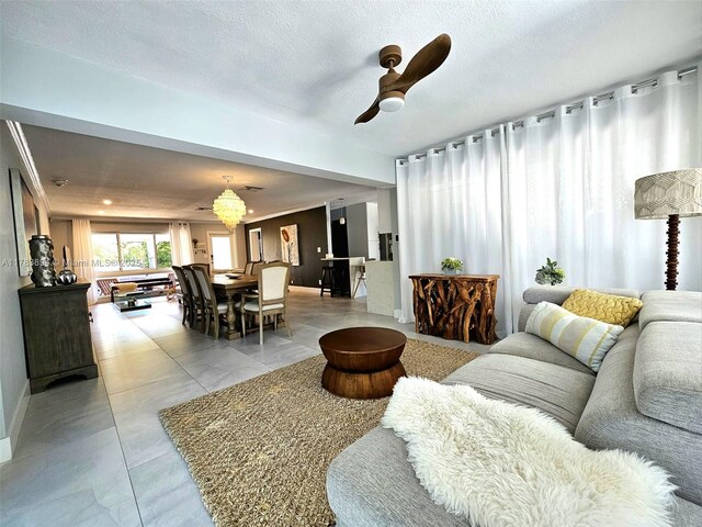 3602 NE 18th Ave, Oakland Park, FL 33334 - living area featuring light tile patterned floors, a textured ceiling, and a ceiling fan