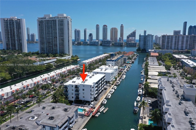 birds eye view of property with a city view and a water view