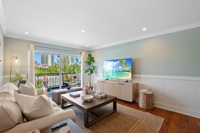living area with recessed lighting, wood-type flooring, ornamental molding, and a wainscoted wall