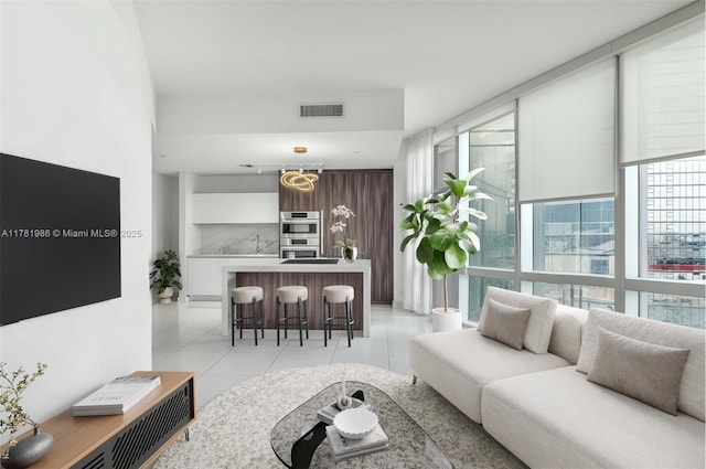 living area featuring visible vents and light tile patterned floors