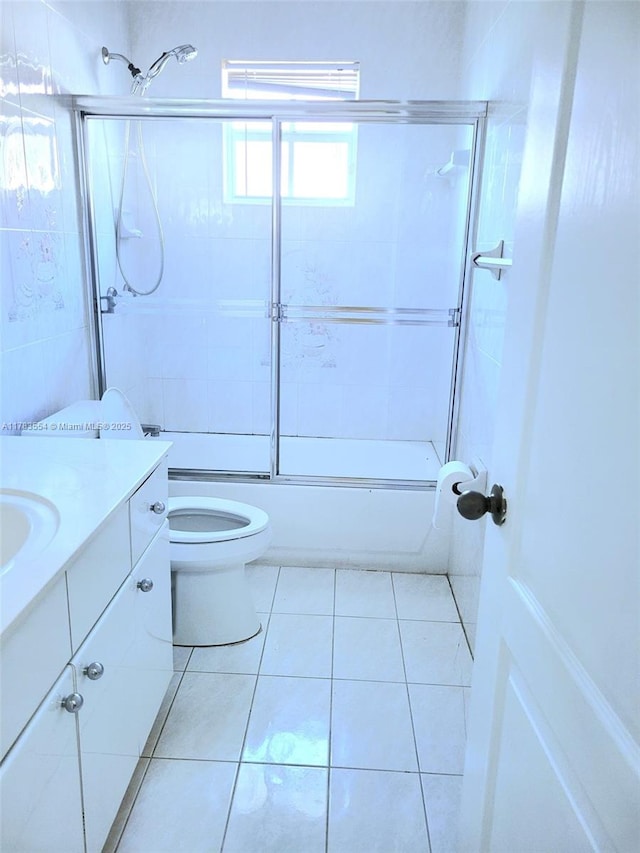 full bathroom with tile patterned floors, toilet, vanity, and enclosed tub / shower combo
