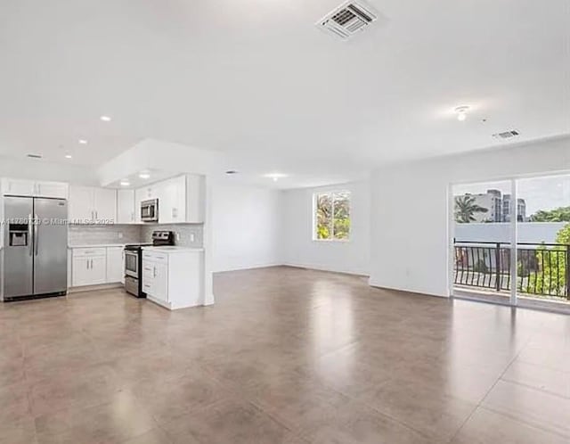 unfurnished living room featuring visible vents and recessed lighting