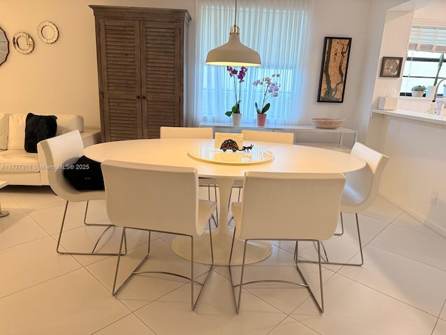 dining area featuring light tile patterned floors
