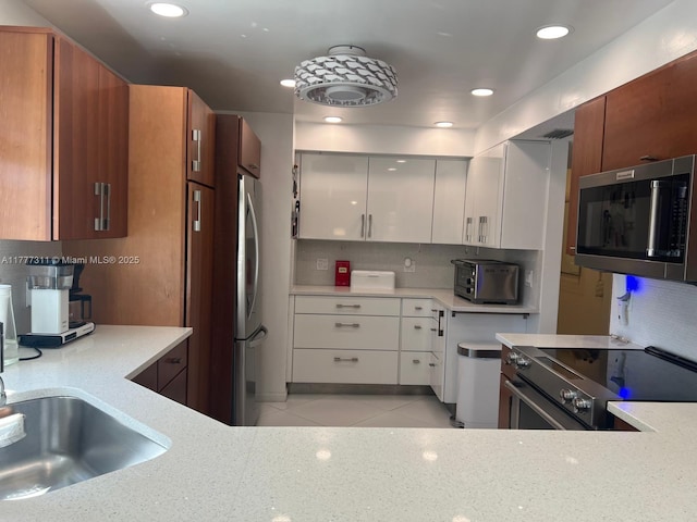 kitchen with decorative backsplash, recessed lighting, a toaster, and stainless steel appliances