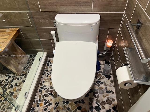 interior details with toilet and a stall shower
