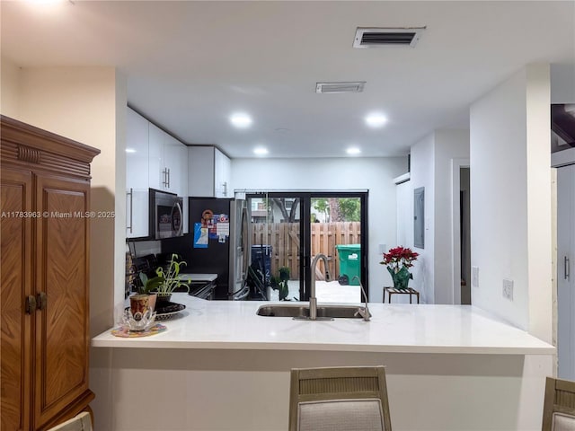 10505 SW 153rd Ct Unit 2, Miami, FL 33196 - kitchen with visible vents, electric panel, a sink, appliances with stainless steel finishes, and a peninsula
