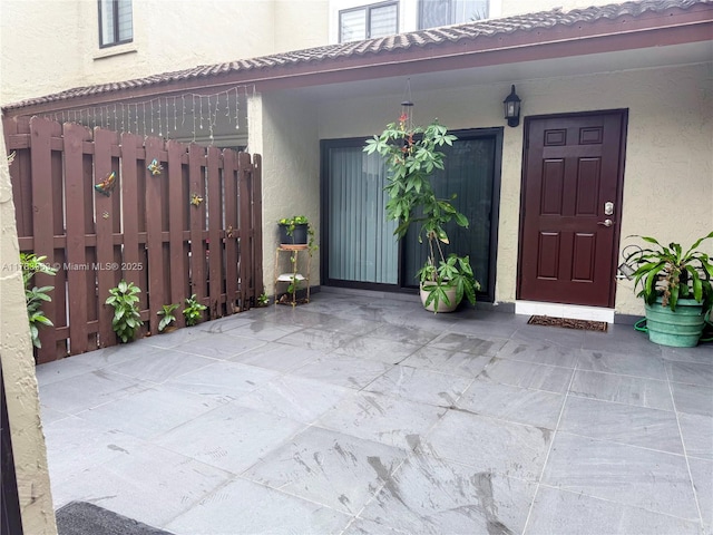 10505 SW 153rd Ct Unit 2, Miami, FL 33196 - property entrance featuring stucco siding, a tiled roof, and fence