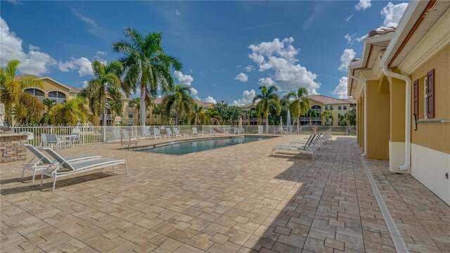 4105 Residence Dr Unit 709, Fort Myers, FL 33901 - community pool with a patio area and fence