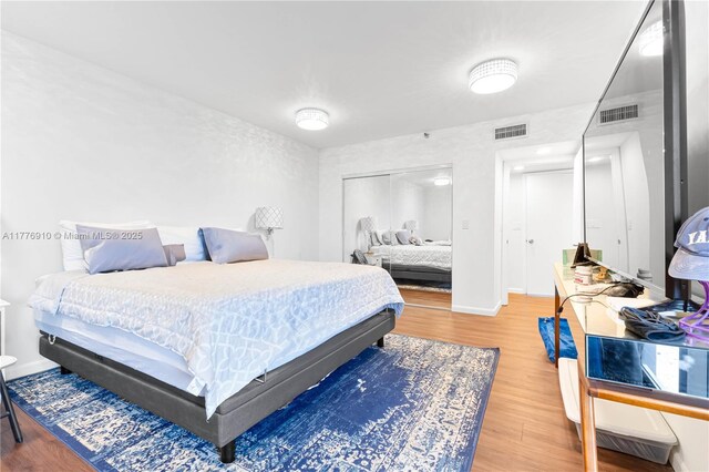 19667 Turnberry Way Unit 3F, Aventura, FL 33180 - bedroom featuring wood finished floors, baseboards, and a closet