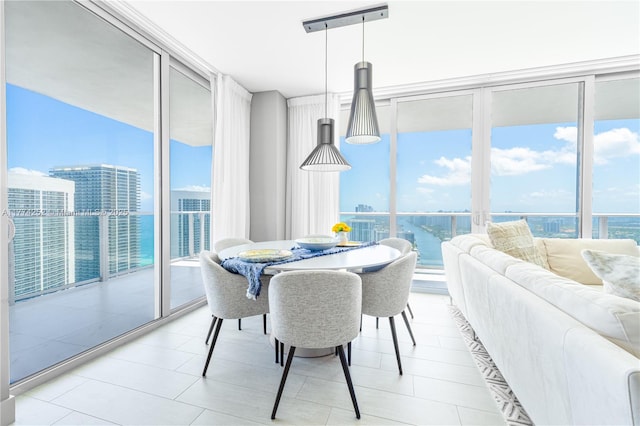 4010 S Ocean Dr Unit T3609, Hollywood, FL 33019 - dining area featuring expansive windows, a water view, and light tile patterned flooring