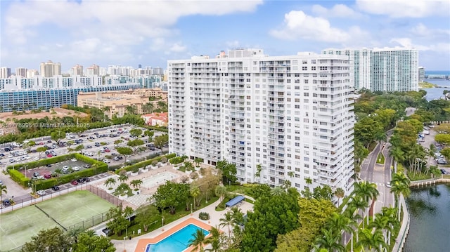 birds eye view of property with a water view and a view of city