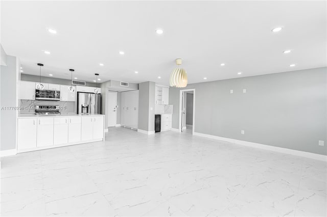 unfurnished living room featuring recessed lighting, visible vents, baseboards, and marble finish floor