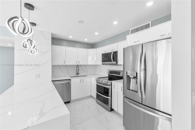 kitchen featuring stainless steel appliances, recessed lighting, visible vents, and a sink