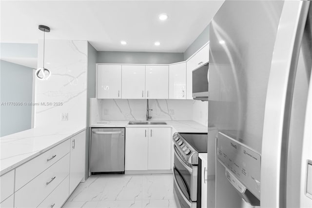 kitchen featuring white cabinets, recessed lighting, appliances with stainless steel finishes, marble finish floor, and a sink