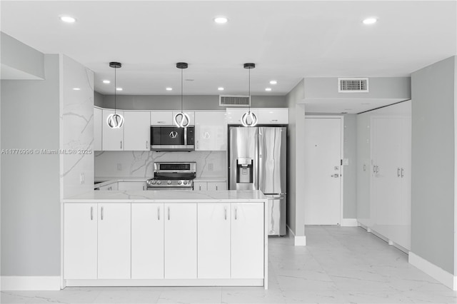kitchen featuring visible vents, appliances with stainless steel finishes, marble finish floor, and a peninsula