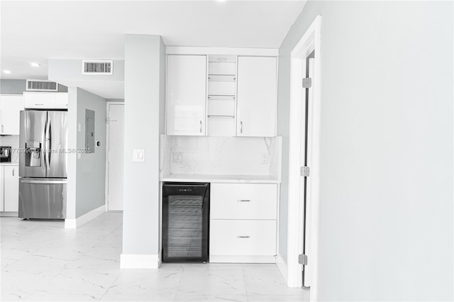 bar with wine cooler, marble finish floor, stainless steel fridge, and visible vents