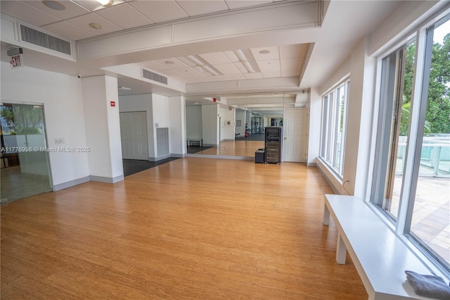 interior space with light wood-style floors, baseboards, and visible vents