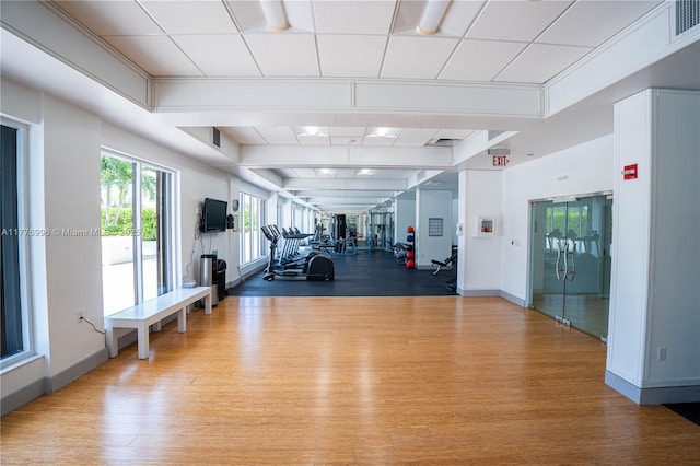 workout area featuring baseboards and wood finished floors