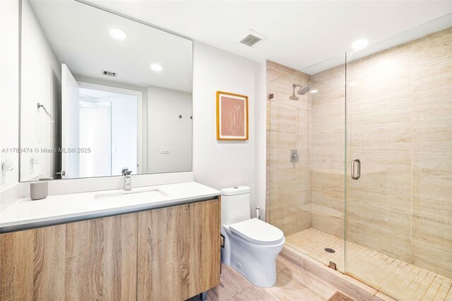 full bathroom featuring toilet, visible vents, and a stall shower