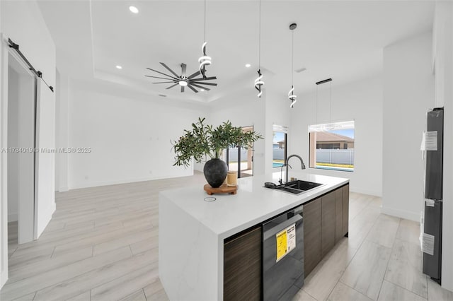 2138 SW 3rd Ave, Cape Coral, FL 33991 - kitchen with modern cabinets, stainless steel dishwasher, light countertops, a kitchen island with sink, and hanging light fixtures