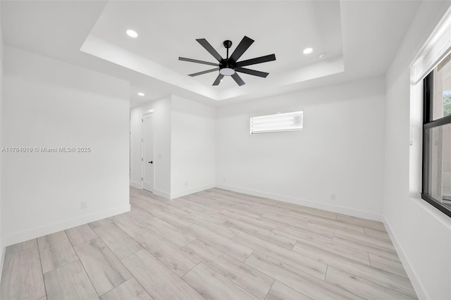 2138 SW 3rd Ave, Cape Coral, FL 33991 - unfurnished room featuring a tray ceiling, recessed lighting, ceiling fan, and light wood-type flooring