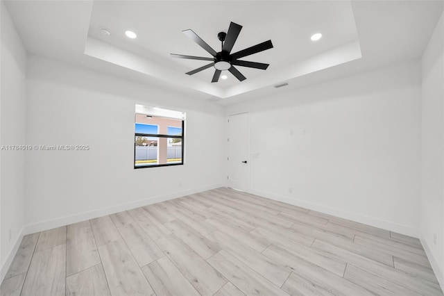 2138 SW 3rd Ave, Cape Coral, FL 33991 - unfurnished room with a tray ceiling, a ceiling fan, recessed lighting, and light wood-style flooring