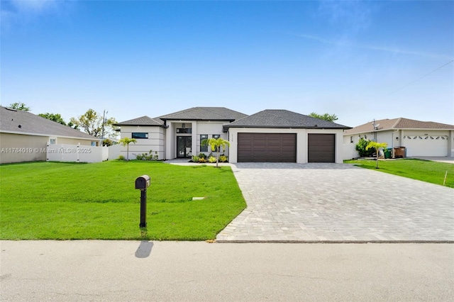 2138 SW 3rd Ave, Cape Coral, FL 33991 - prairie-style home with a front lawn, decorative driveway, an attached garage, and stucco siding