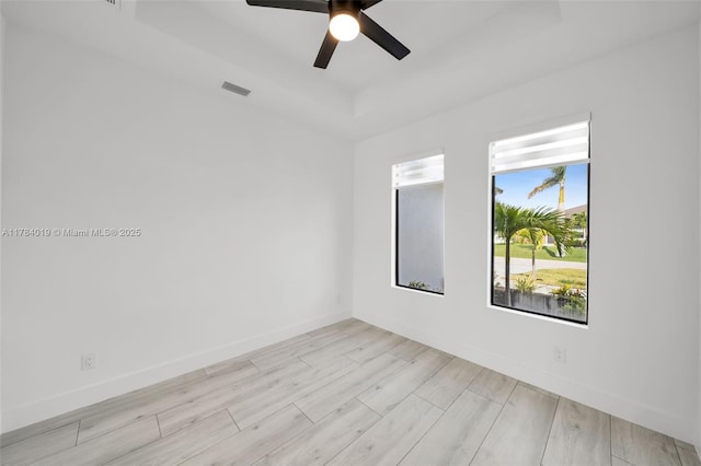 2138 SW 3rd Ave, Cape Coral, FL 33991 - spare room with a raised ceiling, light wood-style flooring, and ceiling fan