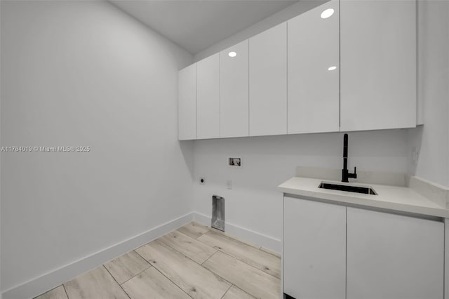 2138 SW 3rd Ave, Cape Coral, FL 33991 - laundry room with hookup for a washing machine, cabinet space, hookup for an electric dryer, light wood-style flooring, and recessed lighting