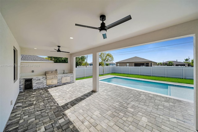 2138 SW 3rd Ave, Cape Coral, FL 33991 - view of pool featuring an outdoor kitchen, a fenced backyard, a ceiling fan, and a patio