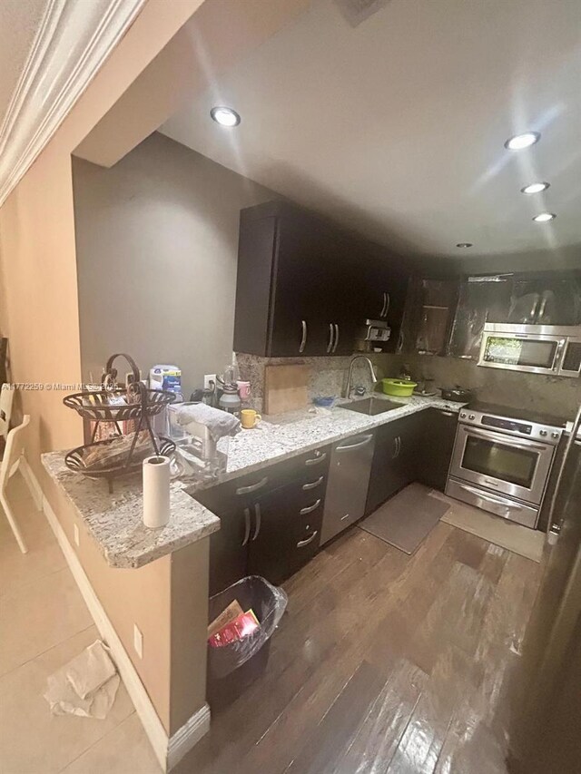 470 N Laurel Dr Unit 6A, Margate, FL 33063 - kitchen with a sink, appliances with stainless steel finishes, light stone counters, a peninsula, and wood finished floors