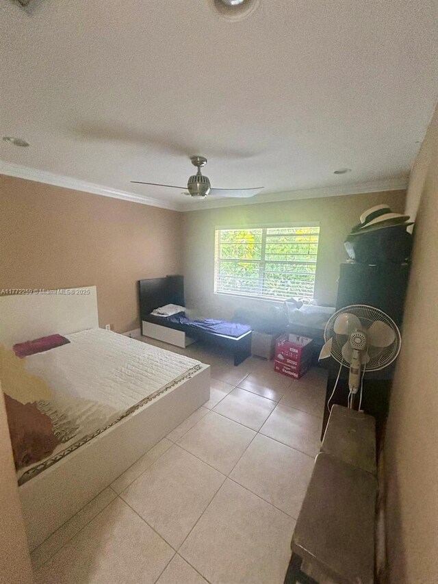 470 N Laurel Dr Unit 6A, Margate, FL 33063 - unfurnished bedroom with crown molding, light tile patterned floors, and a ceiling fan