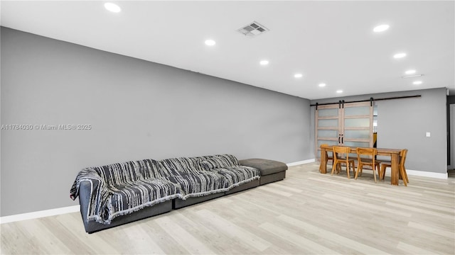 6582 SW 20th St, North Lauderdale, FL 33068 - living room featuring a barn door, recessed lighting, and light wood-type flooring