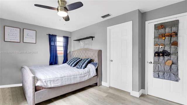 bedroom with visible vents, baseboards, and light wood-type flooring