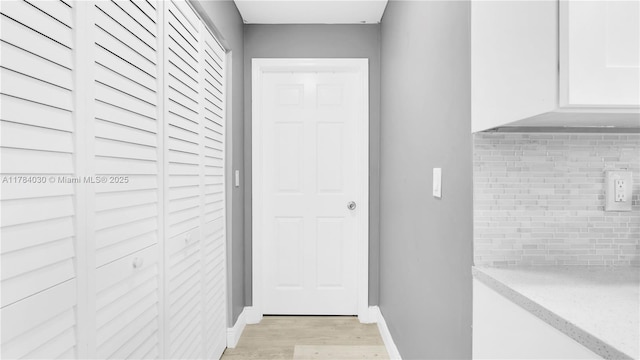 doorway to outside featuring light wood-style floors and baseboards