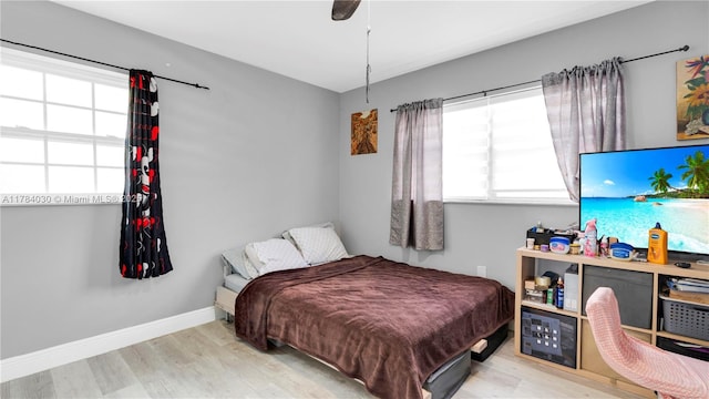 bedroom featuring wood finished floors and baseboards