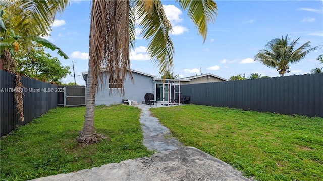 view of yard with a fenced backyard