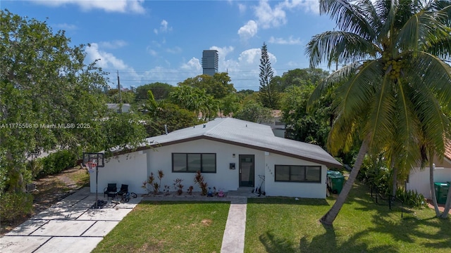 21341 NE 25th Ct, Aventura, FL 33180 - view of front of home featuring a patio, a front lawn, and stucco siding
