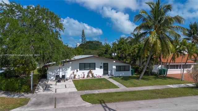 21341 NE 25th Ct, Aventura, FL 33180 - view of front of house featuring driveway, a front yard, and stucco siding