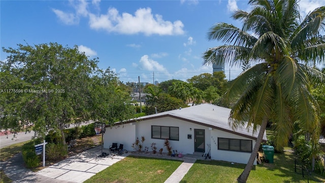 21341 NE 25th Ct, Aventura, FL 33180 - view of front of home featuring a patio, a front lawn, and stucco siding