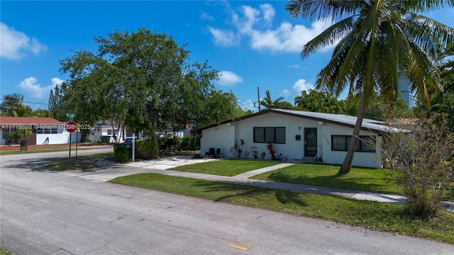 21341 NE 25th Ct, Aventura, FL 33180 - ranch-style home featuring a front yard, stucco siding, and concrete driveway